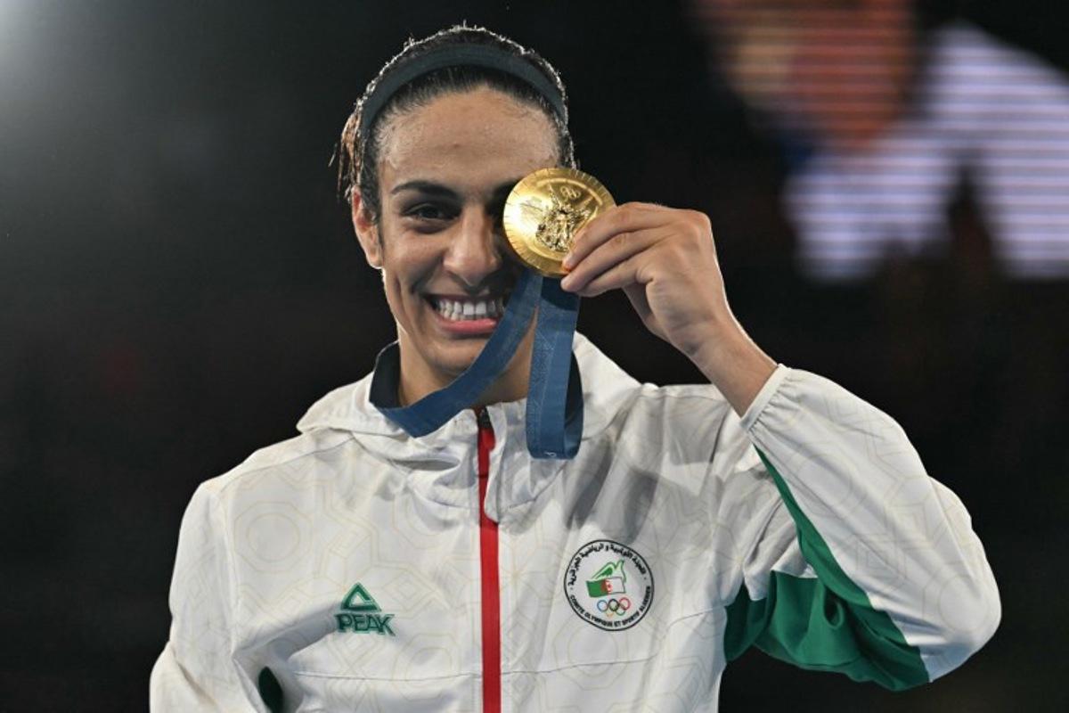 Gold medallist Algeria's Imane Khelif poses on the podium during the medal ceremony for the women's 66kg final boxing category during the Paris 2024 Olympic Games at the Roland-Garros Stadium, in Paris on August 9, 2024. MOHD RASFAN / AFP