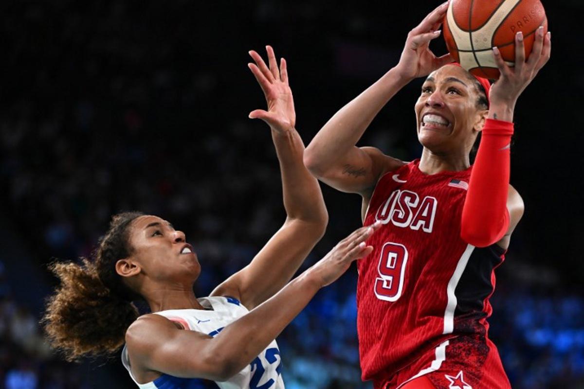 USA's #09 A'ja Wilson goes to the basket past France's #22 Marieme Badiane in the women's Gold Medal basketball match between France and the USA during the Paris 2024 Olympic Games at the Bercy Arena in Paris on August 11, 2024. Aris MESSINIS / AFP