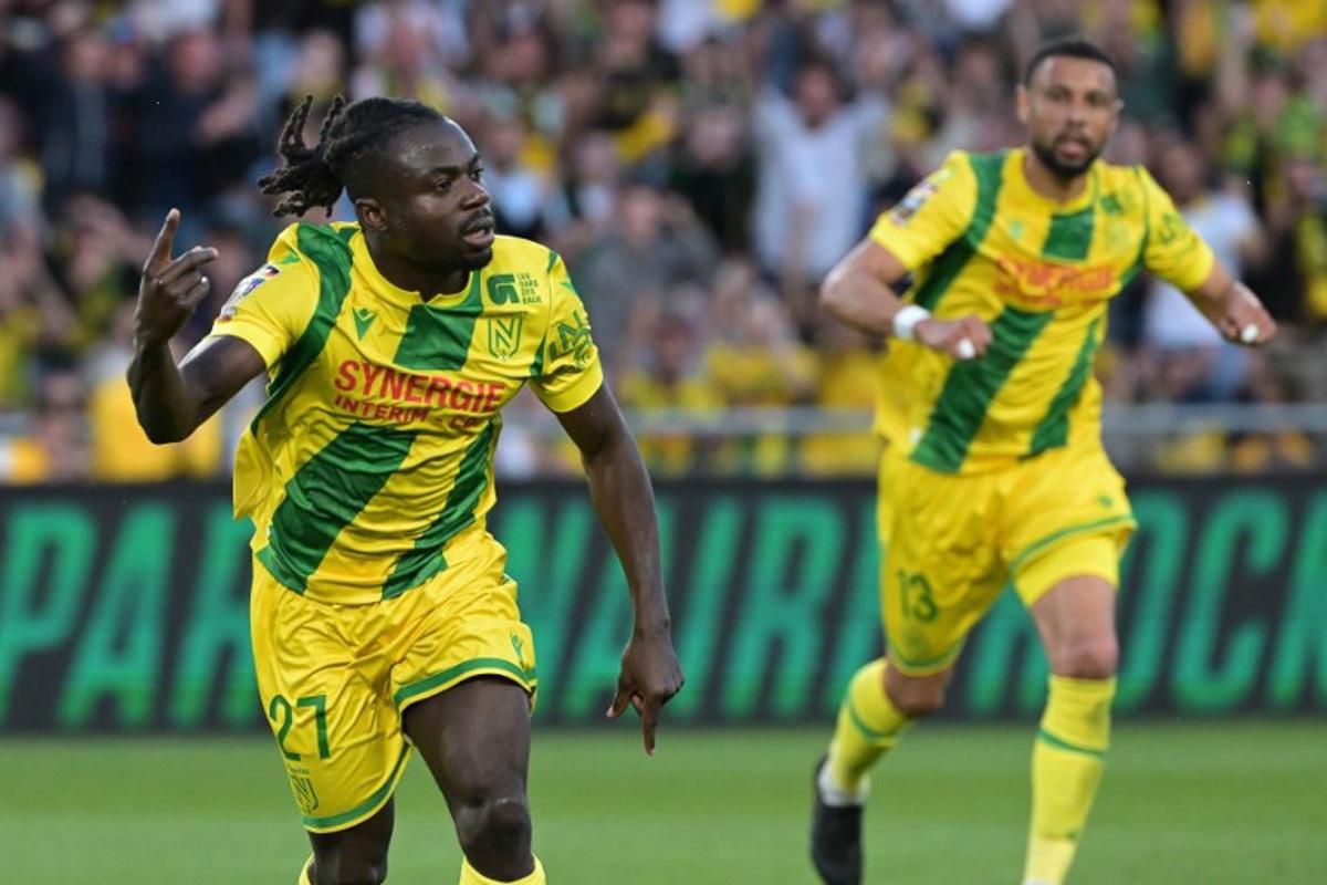Nantes' Nigerian forward #27 Moses Simon (L) celebrates after scoring a penalty kick for the opening goal during the French L1 football match between FC Nantes and Montpellier Herault SC at the Stade de la Beaujoire-Louis Fonteneau in Nantes, western France on May 17, 2025. Damien Meyer / AFP