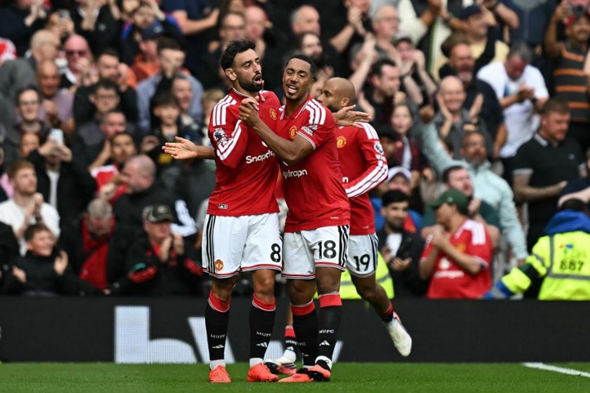 Manchester United's Portuguese midfielder #08 Bruno Fernandes (L) celebrates after scoring the team's first goal during the English Premier League football match between Manchester United and Ipswich Town at Old Trafford in Manchester, north west England, on August 30, 2026. Paul ELLIS / AFP