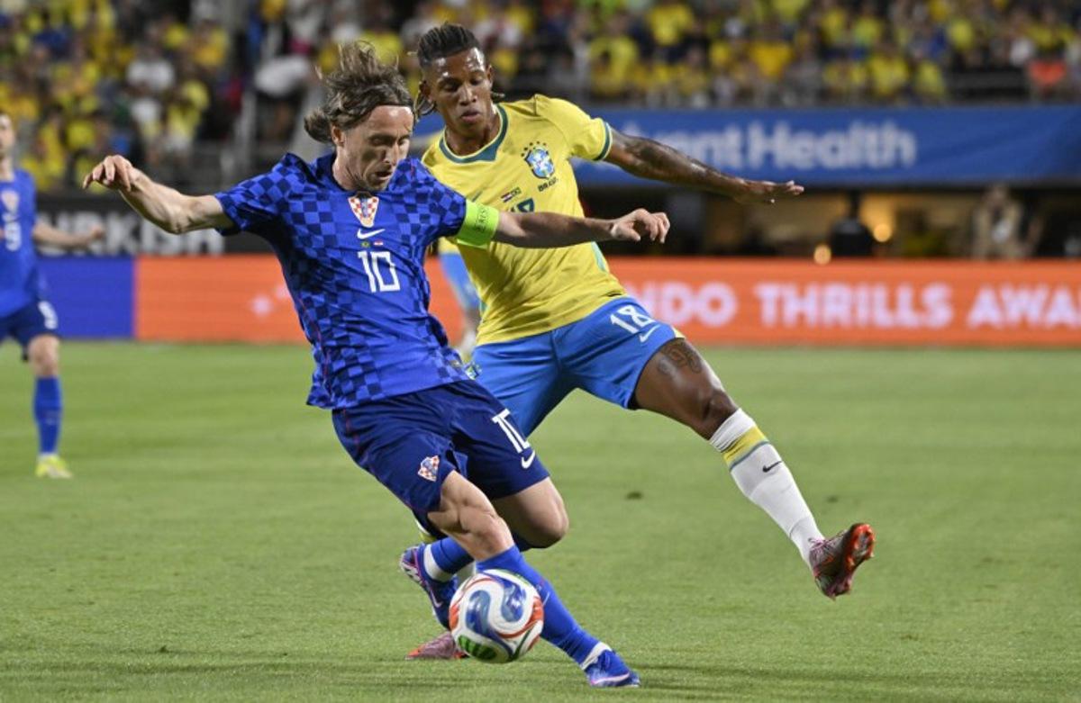Croatia's midfielder #10 Luka Modric and Brazil's midfielder #18 Danilo De Oliveira vie for the ball during a friendly football match between Brazil and Croatia at Camping World Stadium in Orlando, Florida, on March 31, 2026. MIGUEL J RODRIGUEZ CARRILLO / AFP
