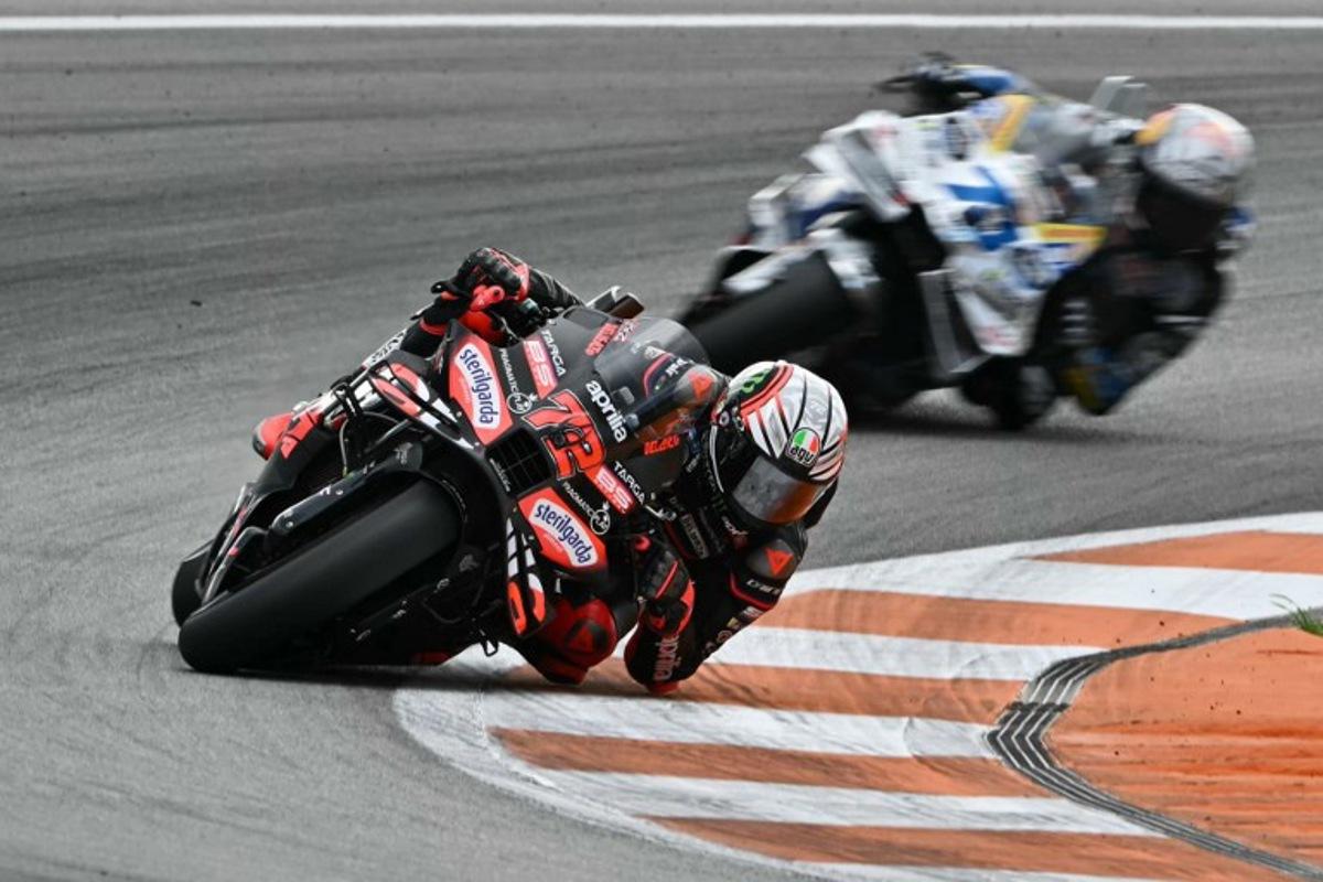 Aprilia Racing team's Italian MotoGP rider Marco Bezzecchi rides ahead of BK8 Gresini Racing MotoGP team's Spanish MotoGP rider Alex Marquez in the MotoGP race of the Valencia Grand Prix at the Ricardo Tormo racetrack in Cheste on November 16, 2025. Javier SORIANO / AFP
