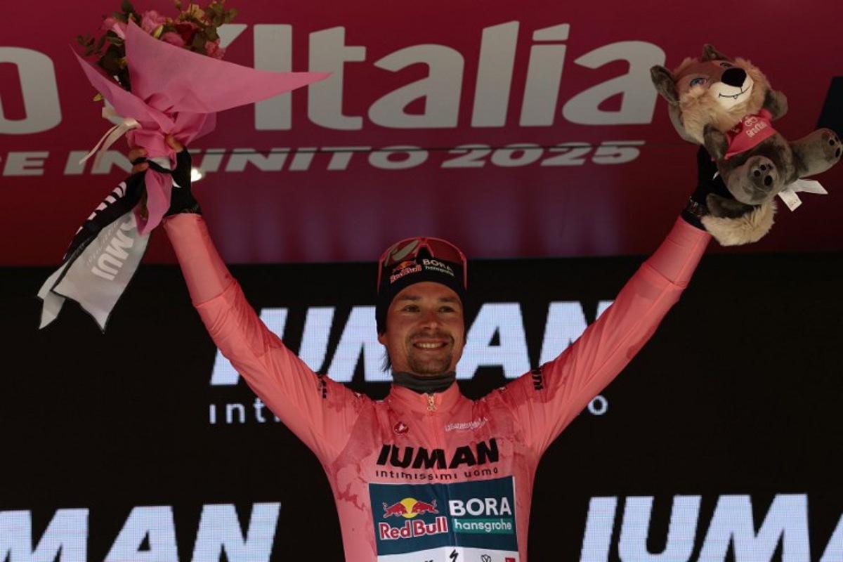 Red Bull-Bora-Hansgrohe's Slovenian rider Primoz Roglic celebrates the Pink jersey of the overall leader on the podium after the 7th stage of the 108th Giro d'Italia cycling race 168kms from Castel di Sangro to Tagliacozzo on May 16, 2025. Luca Bettini / AFP