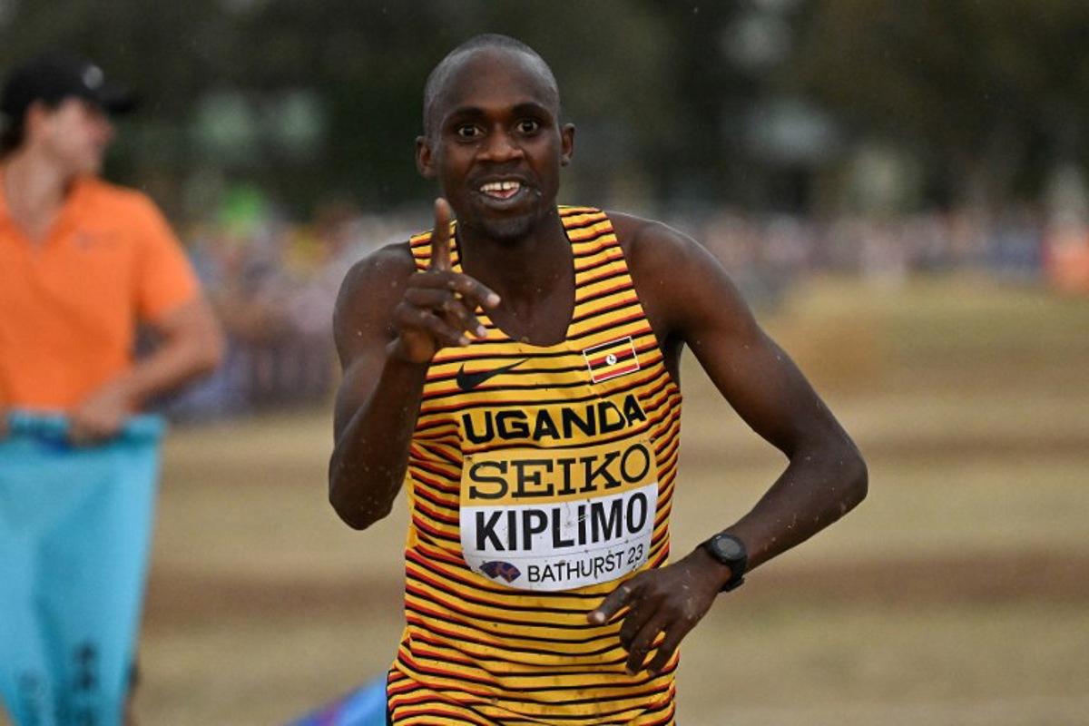 Uganda's Jacob Kiplimo celebrates after crossing the finish line to win the men's senior race during the 2023 World Cross Country Championships at Mount Panorama in Bathurst on February 18, 2023. Saeed KHAN / AFP