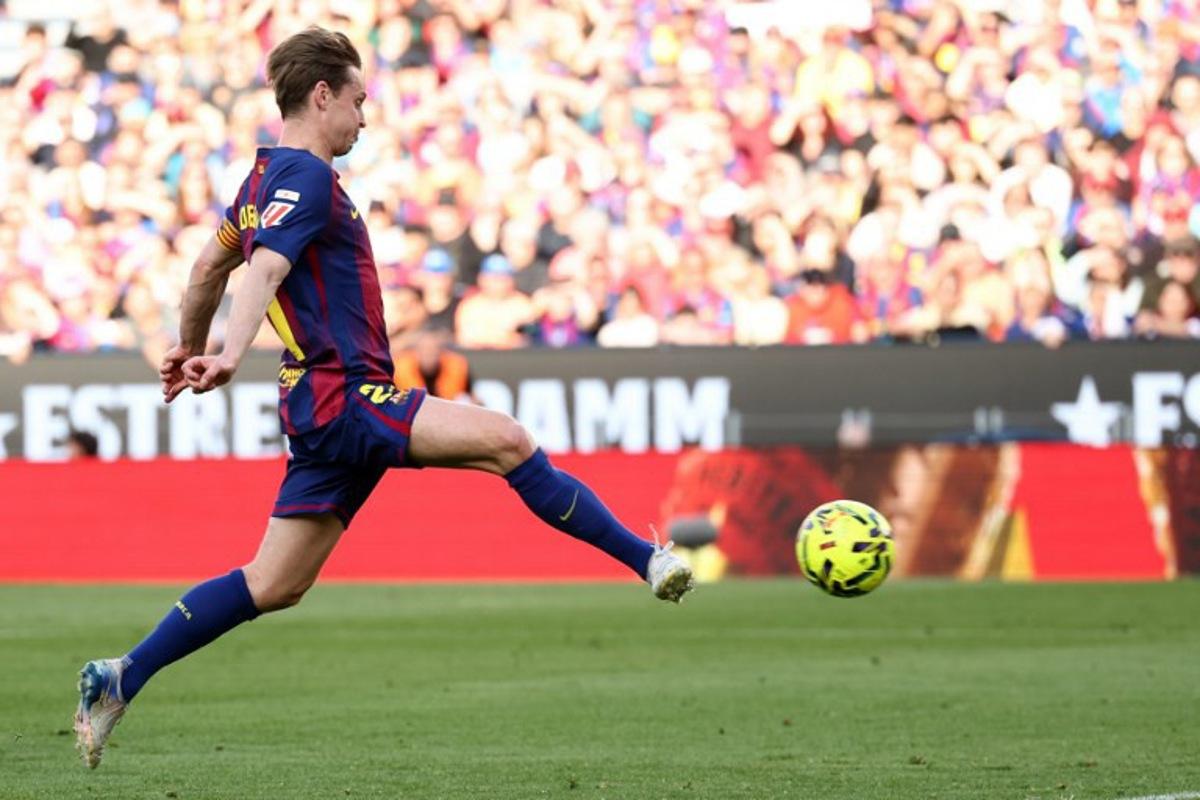 Barcelona's Dutch midfielder #21 Frenkie De Jong scores his team's second goal during the Spanish league football match between FC Barcelona and Levante UD at Camp Nou Stadium in Barcelona on February 22, 2026. Josep LAGO / AFP