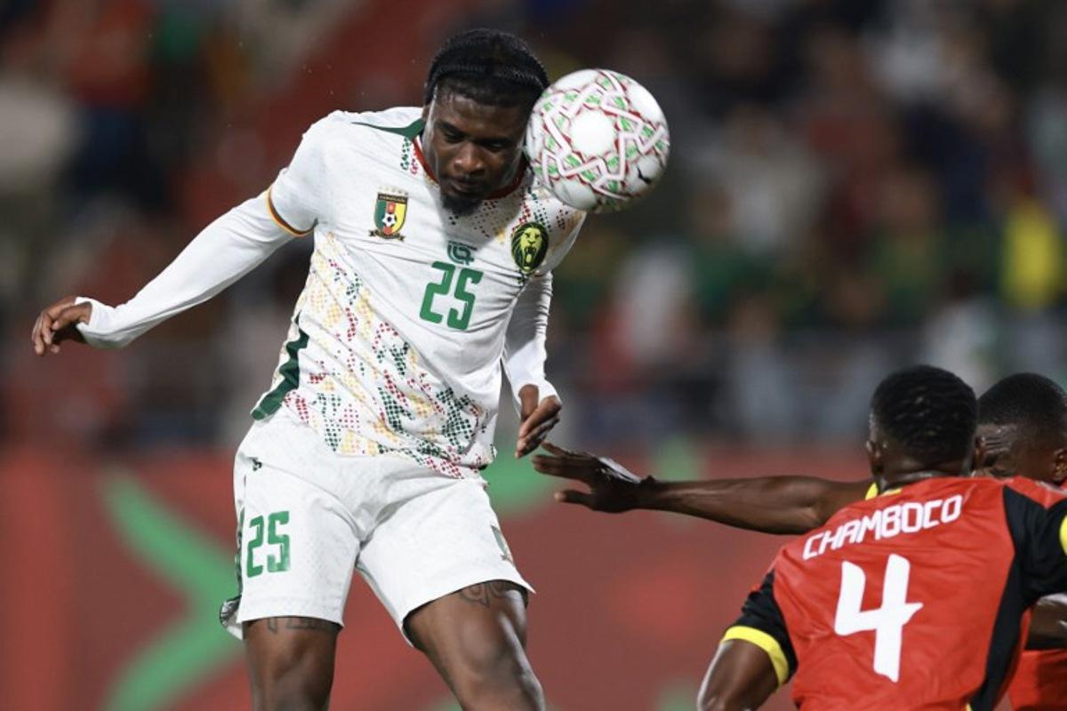 Cameroon's midfielder #25 Junior Dina Ebimbeheads the ball during the Africa Cup of Nations (CAN) Group F football match between Mozambique and Cameroon at the Grand Stadium in Agadir on December 31, 2025. FRANCK FIFE / AFP