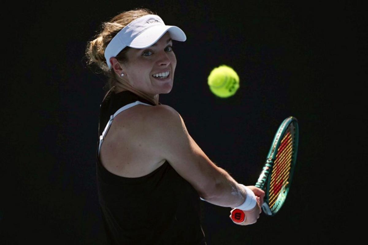 USA's Caty McNally hits a return against Japan's Himeno Sakatsume during their women's singles match on day one of the Australian Open tennis tournament in Melbourne on January 18, 2026. WILLIAM WEST / AFP