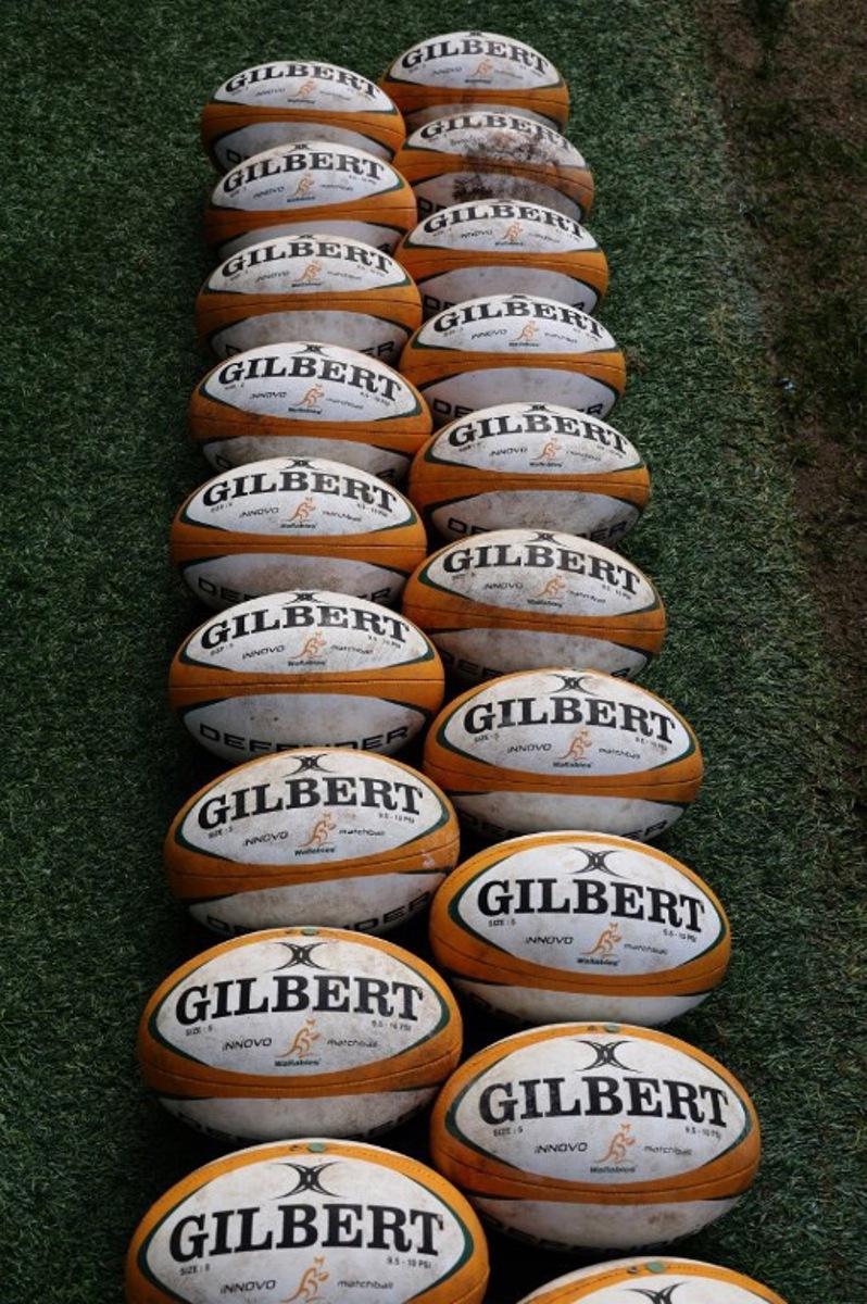 Rugby balls are lined up during the Australia's Captain's Run at Allianz Stadium on July 5, 2024 in Sydney ahead of the first rugby Test between Australian Wallabies and Wales. DAVID GRAY / AFP