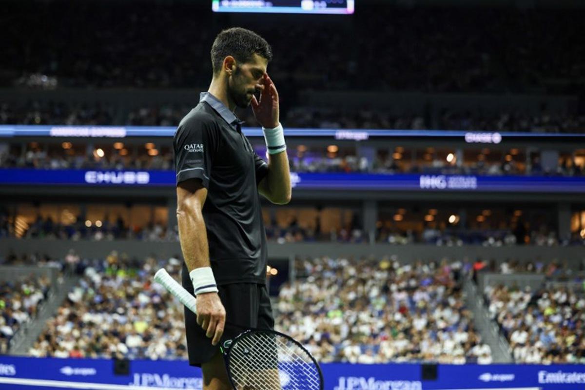 Serbia's Novak Djokovic reacts during a match against Argentina's Mariano Navone during the men's singles first round tennis match on day one of the US Open tennis tournament at the USTA Billie Jean King National Tennis Center in New York City on August 30, 2026. CHARLY TRIBALLEAU / AFP