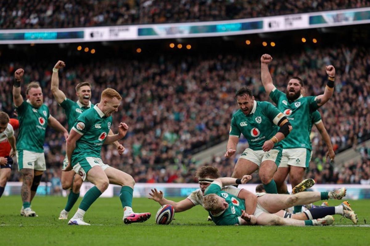Ireland's full-back Jamie Osborne (C-on ground) goes over to score a try during the Six Nations international rugby union match between England and Ireland at Allianz Stadium, Twickenham, in south-west London, on February 21, 2026. Adrian Dennis / AFP