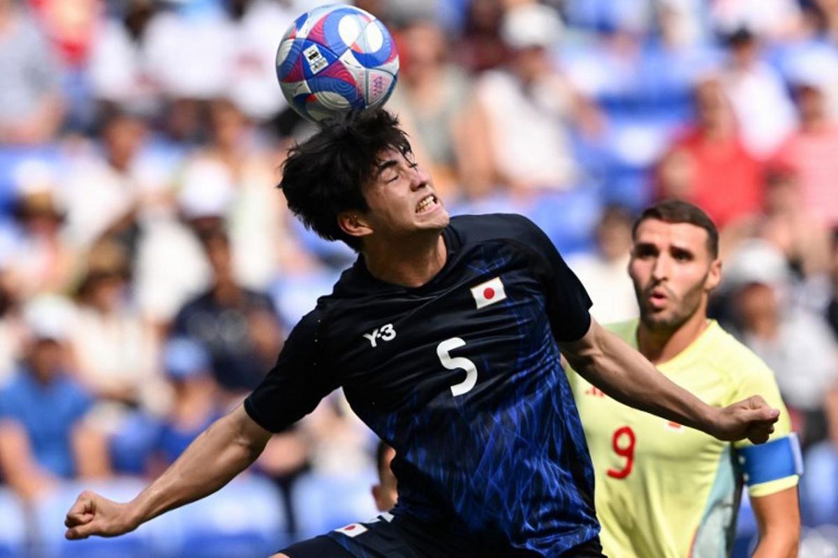 Japan's defender #05 Seiji Kimura heads the ball in the men's quarter-final football match between Japan and Spain during the Paris 2024 Olympic Games at the Lyon Stadium in Lyon on August 2, 2024. Arnaud FINISTRE / AFP