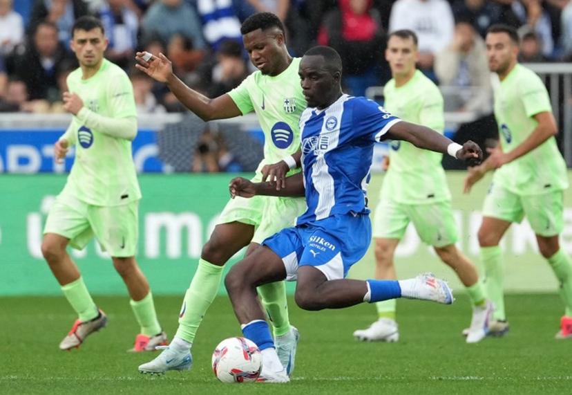 Barcelona's Spanish forward #10 Ansu Fati fights for the ball with Alaves' French defender #22 Moussa Diarra during the Spanish league football match between Deportivo Alaves and FC Barcelona at the Mendizorroza stadium in Vitoria on October 6, 2024. Cesar Manso / AFP