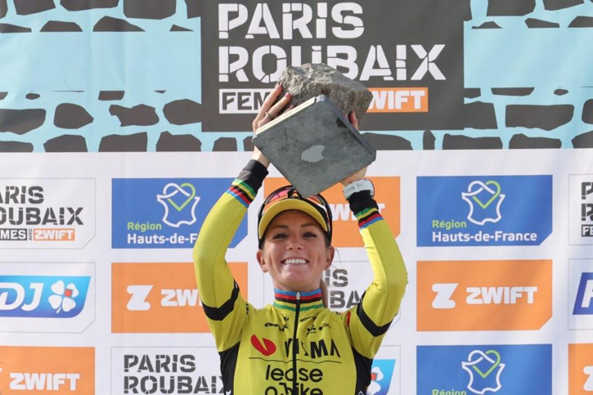First placed Team Visma-Lease a Bike's French rider Pauline Ferrand Prevot celebrates with her award on the podium of the fifth edition of the Paris-Roubaix women's race, 148,5 km between Denain and Roubaix, northern France on April 12, 2025. Francois LO PRESTI / AFP