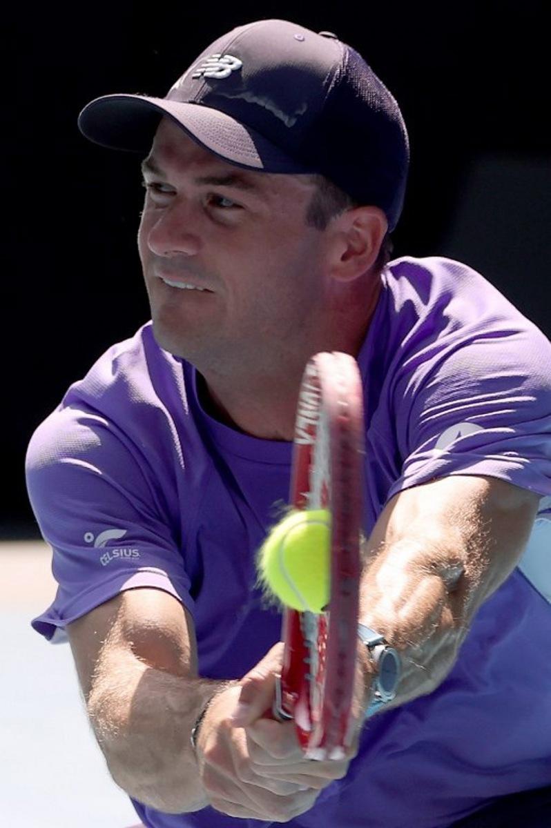 USA's Tommy Paul hits a return to Spain's Carlos Alcaraz during their men's singles match on day eight of the Australian Open tennis tournament in Melbourne on January 25, 2026. DAVID GRAY / AFP
