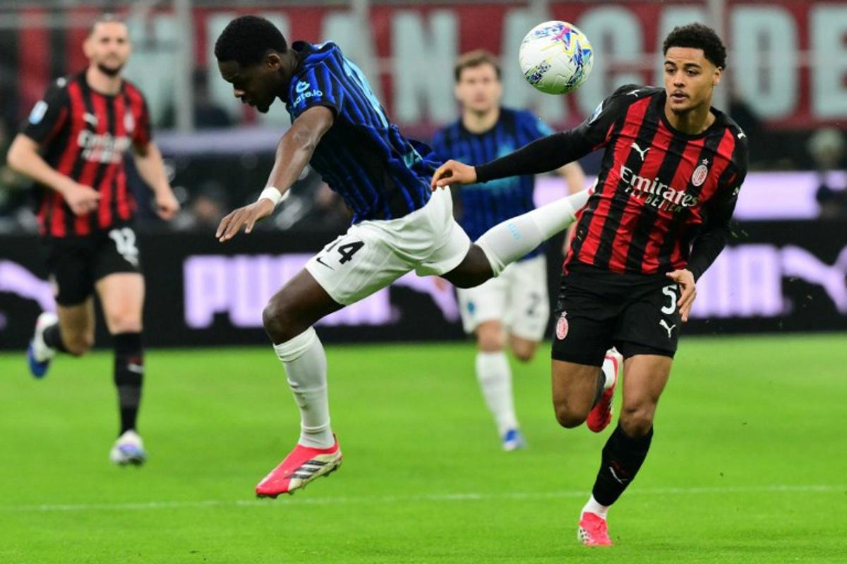 Inter Milan's French forward #14 Ange-Yoan Bonny (L) fights for the ball with AC Milan's Belgian defender #05 Koni De Winter during the Italian Serie A football match between AC Milan and Inter Milan at San Siro stadium in Milan, northern Italy, on March 8, 2026. Stefano RELLANDINI / AFP