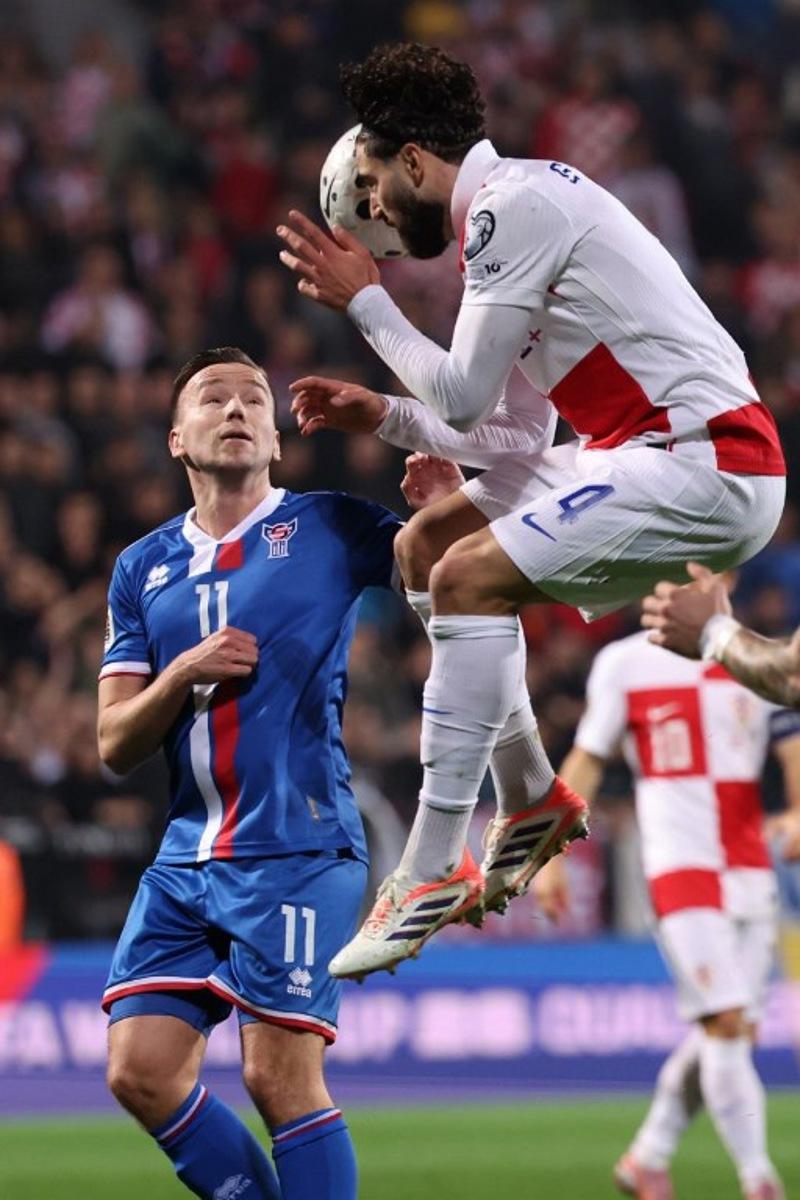 Croatia's defender #04 Josko Gvardiol (R) fights for the ball with Faroe's midfielder #11 Arni Frederiksberg during the 2026 World Cup qualifiers Europe zone group L football match between Croatia and Faroe Islands at the Stadion HNK in Rijeka, on November 14, 2025. STRINGER / AFP