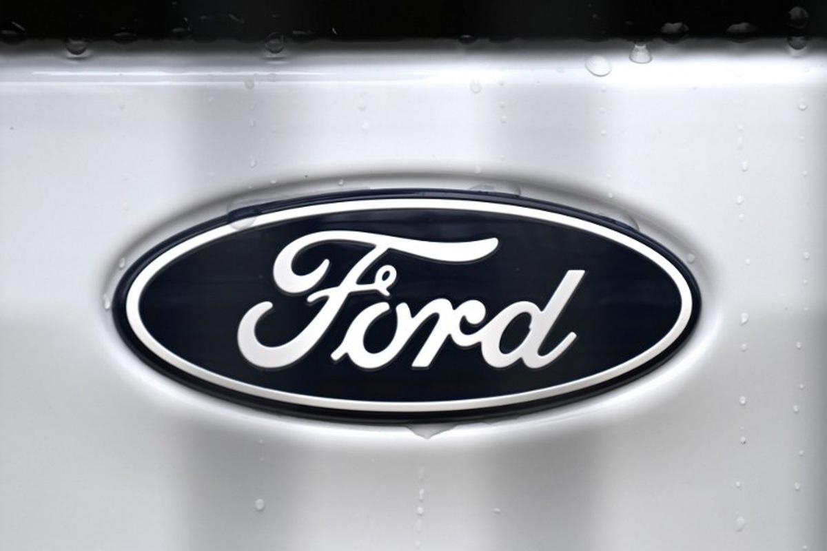 The logo of US car giant Ford is pictured on a car at a carseller in Gelsenkirchen, western Germany, on November 22, 2024. Ford on November 20, 2024 announced 4,000 more job cuts in Europe, mostly in Germany and Britain, in the latest blow to the continent's beleaguered car industry. Ina FASSBENDER / AFP