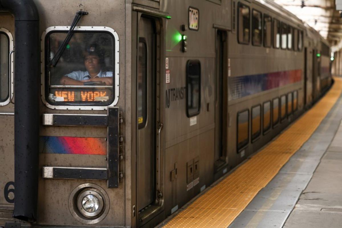An NJ Transit train bound for New York pulls into Newark Penn Station in Newark, New Jersey on April 17, 2026. Football fans have expressed outrage at the exorbitant price of transit fares to get to World Cup matches, following reports that US transport authorities have jacked up prices just for this summer's tournament. New Jersey Transit is planning to charge fans more than $100 for tickets from Penn Station in Manhattan to MetLife Stadium in New Jersey during the World Cup, according to a report in The Athletic. A return ticket for the journey normally costs $12.90. CHARLY TRIBALLEAU / AFP