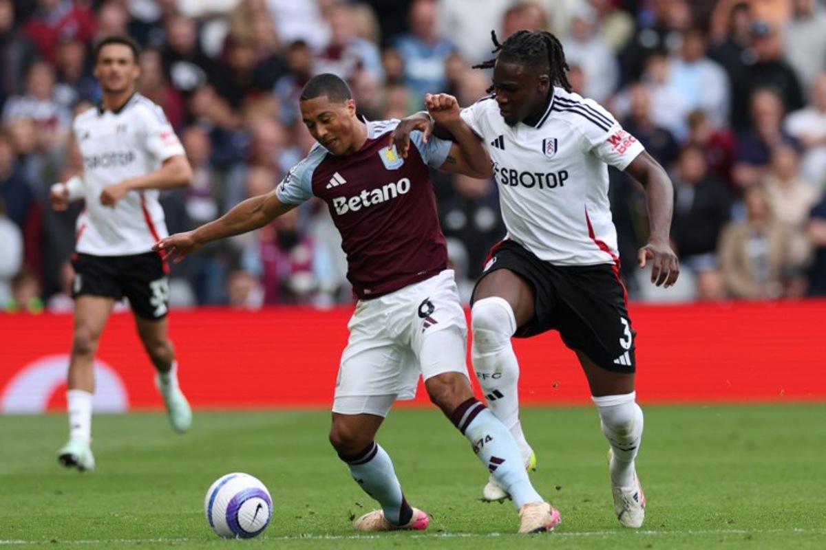 Aston Villa's Belgian midfielder #08 Youri Tielemans (C) is fouled by Fulham's Italian-born Nigerian defender #03 Calvin Bassey (R) during the English Premier League football match between Aston Villa and Fulham at Villa Park in Birmingham, central England on May 3, 2025. Adrian Dennis / AFP