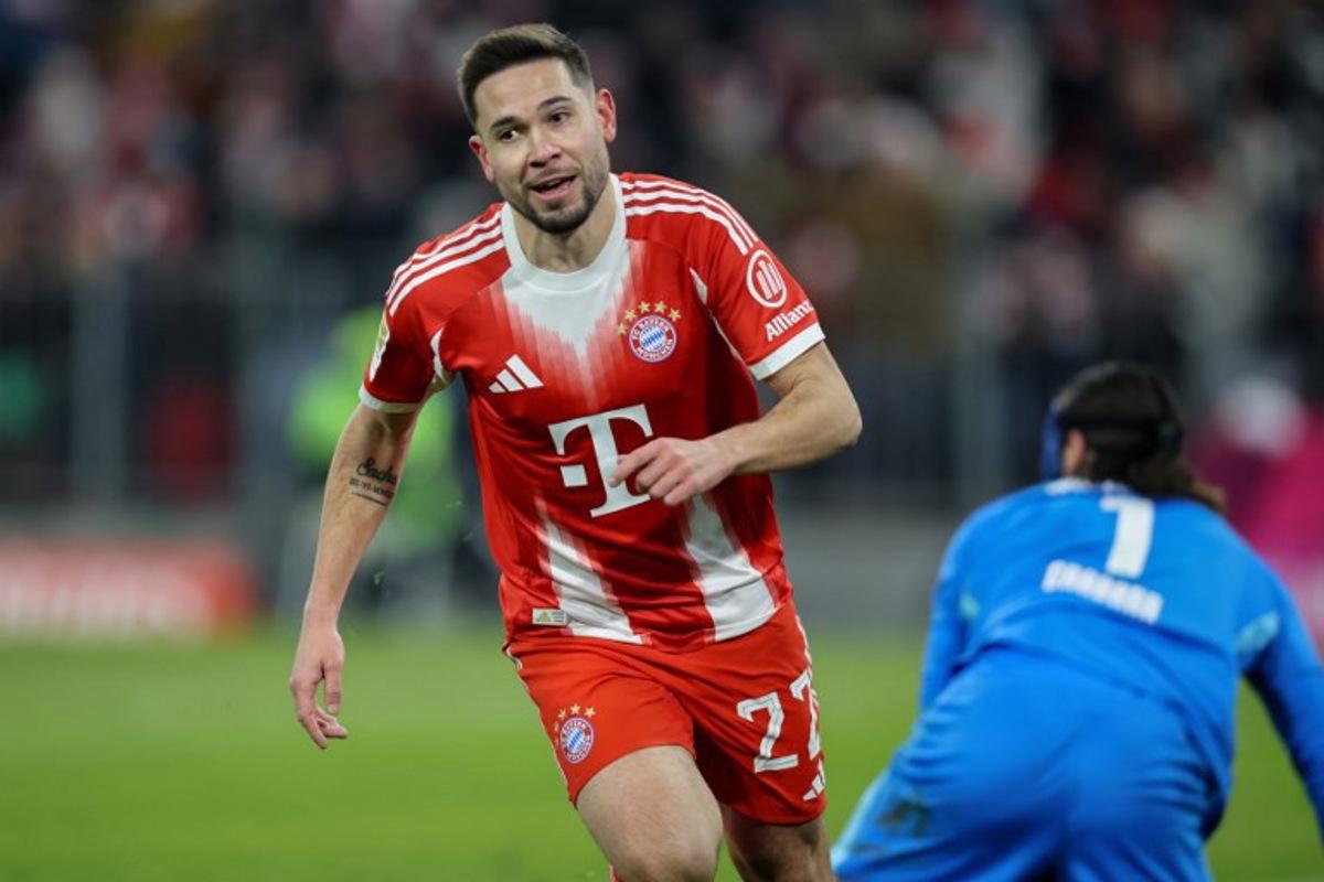 Bayern Munich's Portuguese defender #22 Raphael Guerreiro celebrates scoring the 5-1 goal during the German first division Bundesliga football match between FC Bayern Munich and VfL Wolfsburg in Munich, southern Germany, on January 11, 2026. Alexandra BEIER / AFP