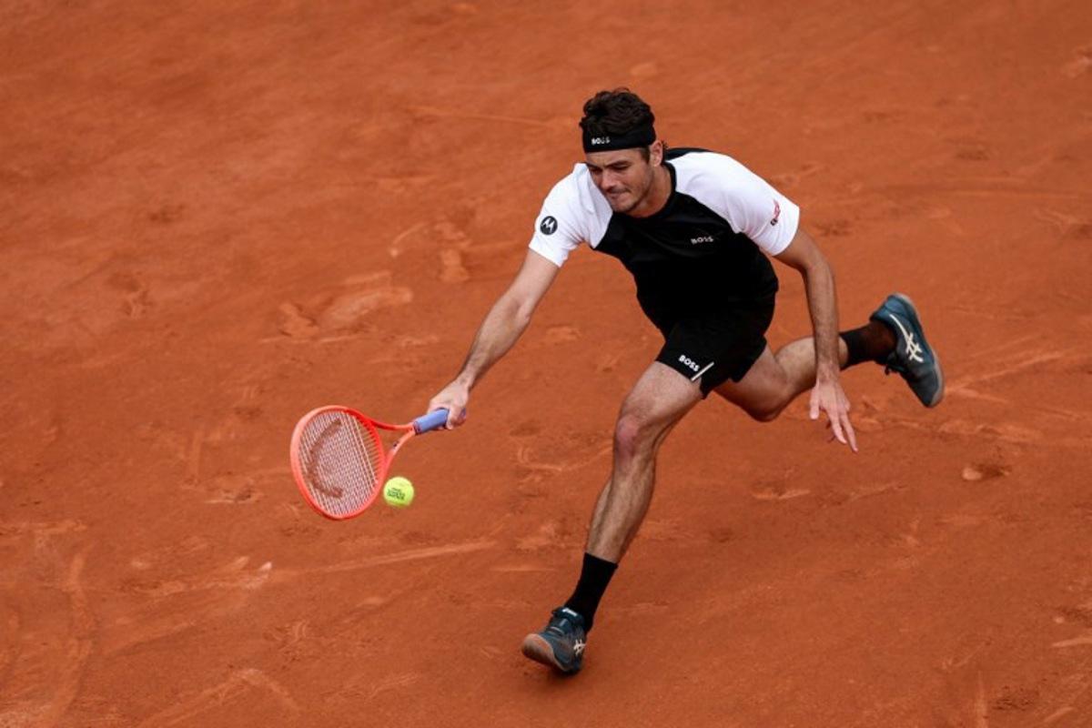 US Taylor Fritz plays a forehand return to Germany's Daniel Altmaier during their men's singles match on day 2 of the French Open tennis tournament on Court Simonne-Mathieu at the Roland-Garros Complex in Paris on May 26, 2025. Alain JOCARD / AFP