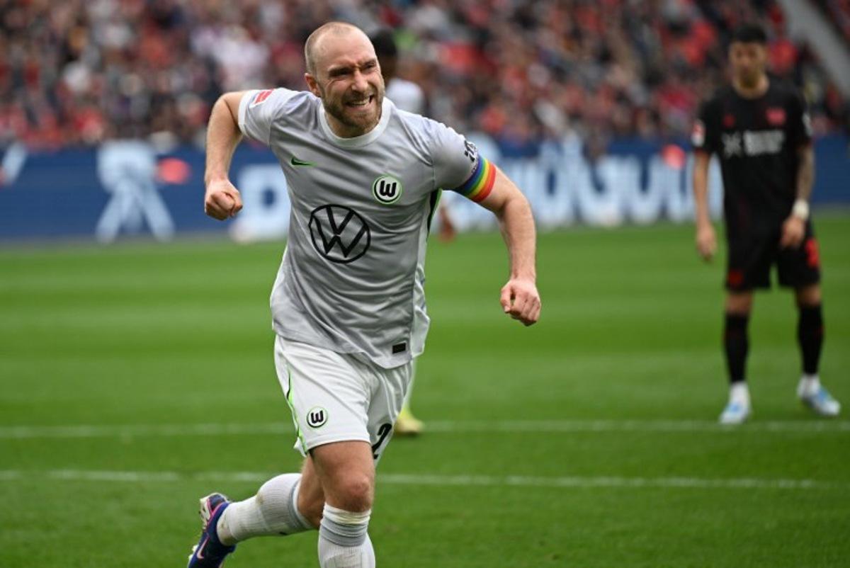 Wolfsburg's Danish midfielder #24 Christian Eriksen celebrates scoring a penalty during the German first division Bundesliga football match between Bayer leverkusen and VfL Wolfsburg in Leverkusen on April 4, 2026. INA FASSBENDER / AFP