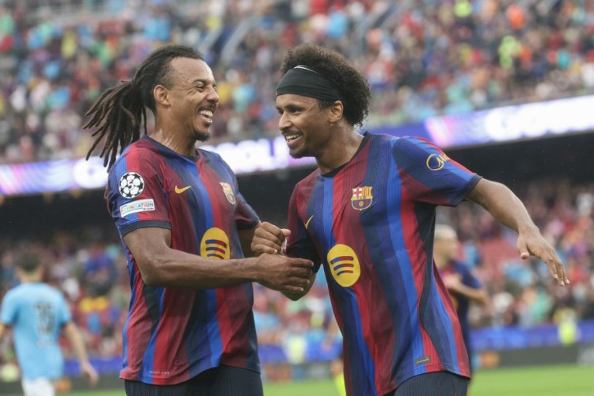 Barcelona's German forward #14 Karim Adeyemi (R) celebrates scoring his team's second goal with teammate Barcelona's French defender #23 Jules Kounde during the UEFA Champions League first round day 1 football match between FC Barcelona and Feyenoord at Camp Nou stadium in Barcelona on September 9, 2026. Lluis GENE / AFP