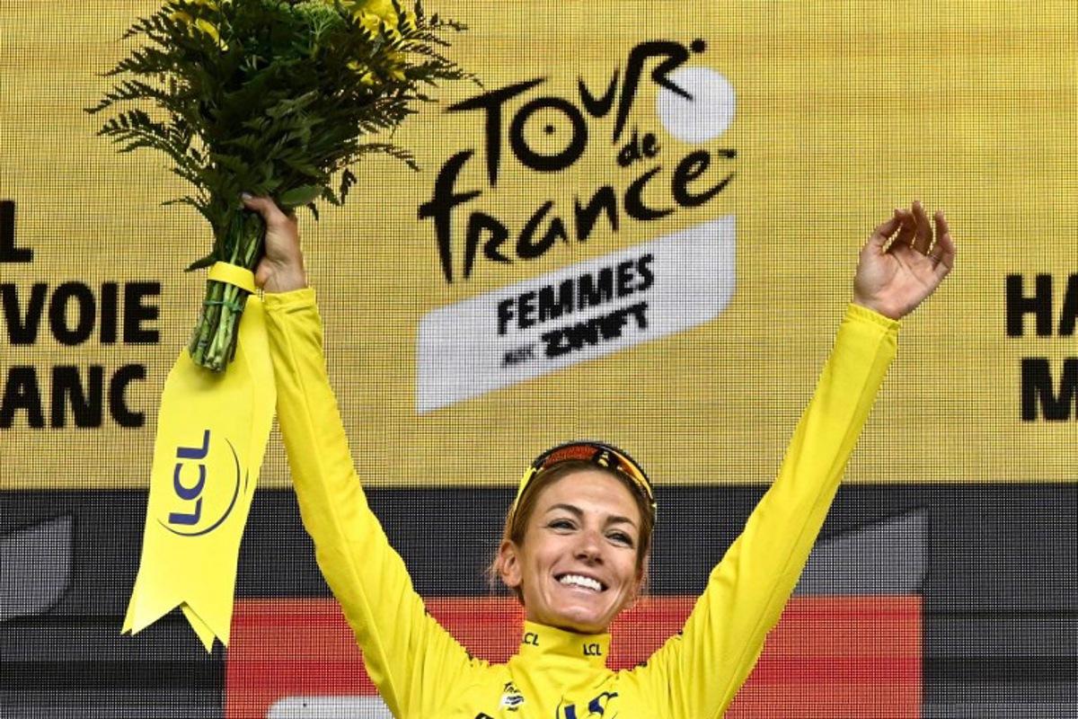 Team Visma | Lease a Bike's French rider Pauline Ferrand-Prevot celebrates with the overall leader's yellow jersey on the podium for the fourth edition of the Women's Tour de France cycling race at the end of the 9th and final stage (out of 9), 124.1 km from Praz-sur-Arly to Chatel, in Chatel eastern France, on August 3, 2025. JULIEN DE ROSA / AFP