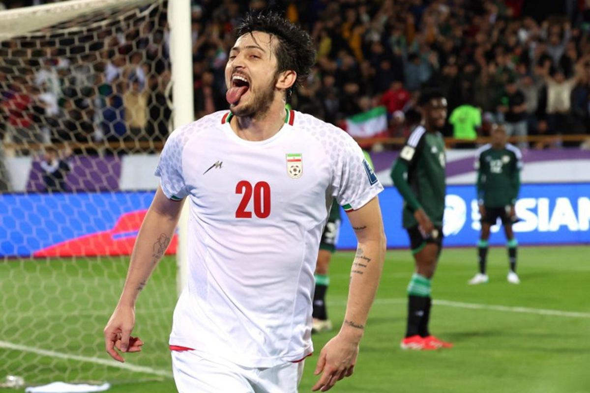 Iran's forward #20 Sardar Azmoun celebrates after scoring their first goal during the FIFA World Cup 2026 Asia zone qualifiers group A football match between Iran and the United Arab Emirates at the Azadi Sports Complex in Tehran on March 20, 2025. AFP