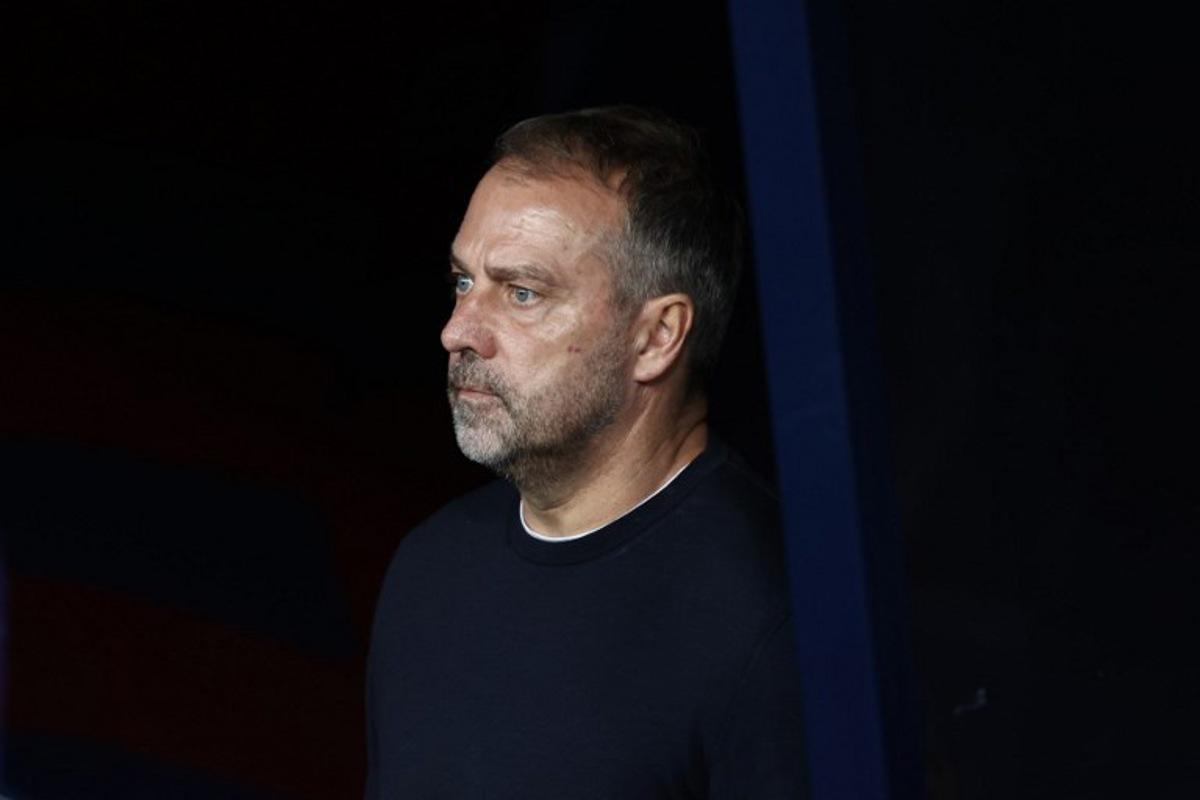 Barcelona's German coach Hans-Dieter Flick looks on during the UEFA Champions League league phase match-day 3 football match between FC Barcelona and Olympiakos FC at Estadi Olimpic Lluis Companys in Barcelona on October 21, 2025. Josep LAGO / AFP