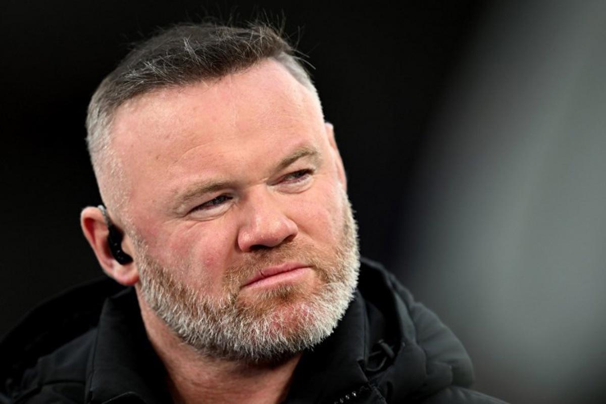 TV pundit and former footballer Wayne Rooney looks on before the UEFA Champions League quarter final, second-leg football match between Liverpool and Paris Saint-Germain at Anfield in Liverpool, north west England on April 14, 2026. Paul ELLIS / AFP