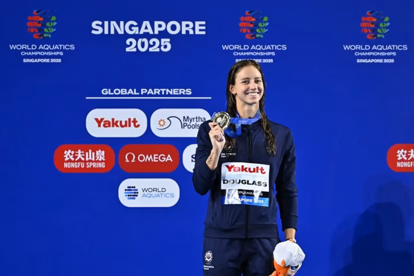 Gold medallist US' swimmer Kate Douglass celebrates on the podium of the women's 200m breaststroke swimming event during the 2025 World Aquatics Championships in Singapore on August 1, 2025. MANAN VATSYAYANA / AFP