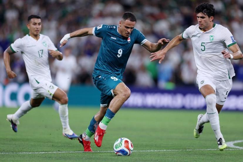 Iraq's forward #09 Ali Al-Hamadi and Bolivia's defender #05 Efrain Morales fight for the ball during the 2026 FIFA World Cup qualifiers final playoff football match between Iraq and Bolivia at the BBVA Stadium in Guadalupe, Nuevo Leon state, Mexico, on March 31, 2026. Julio Cesar AGUILAR / AFP
