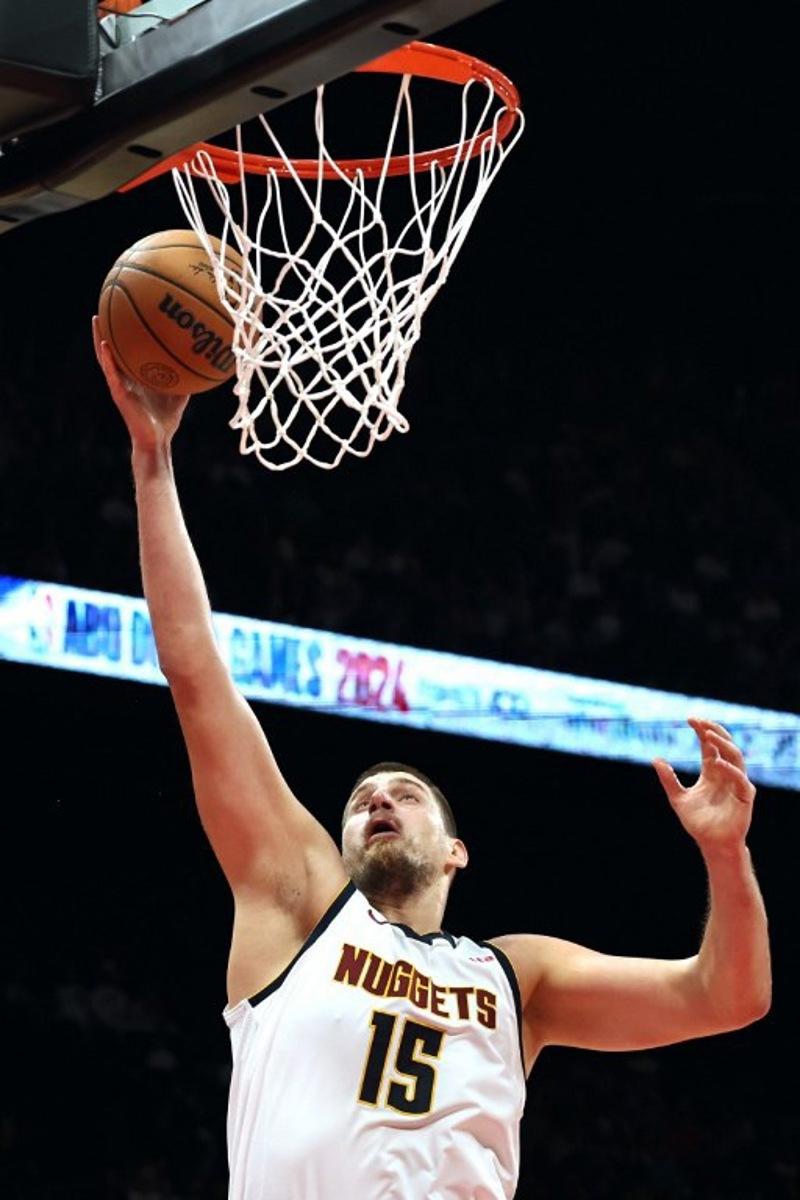 Denver Nuggets' center #15 Nikola Jokic jumps to shoot during the NBA Preseason game between the Boston Celtics and the Denver Nuggets at the Etihad Arena in Abu Dhabi on October 6, 2024. Fadel Senna / AFP