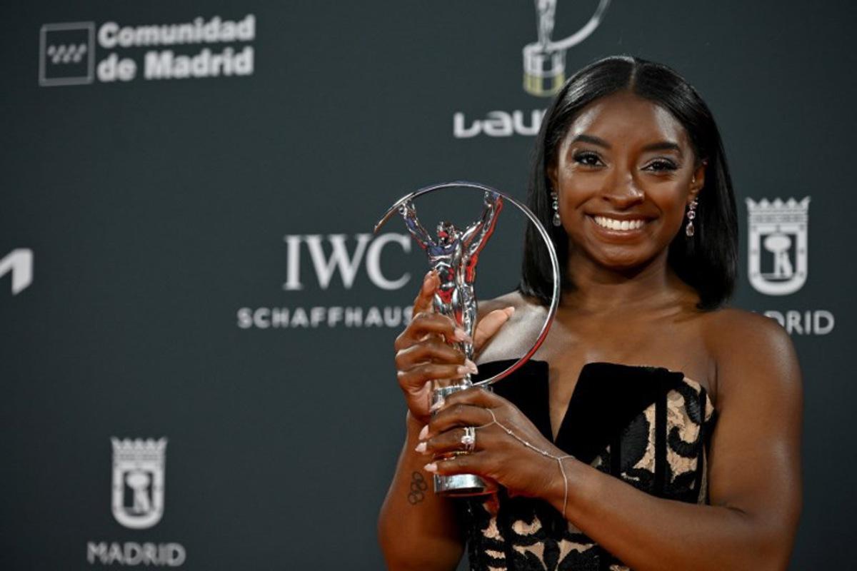 US gymnast Simone Biles poses with her Sportswoman of the Year Award during the 26th Laureus World Sports Awards gala in Madrid on April 21, 2025. JAVIER SORIANO / AFP