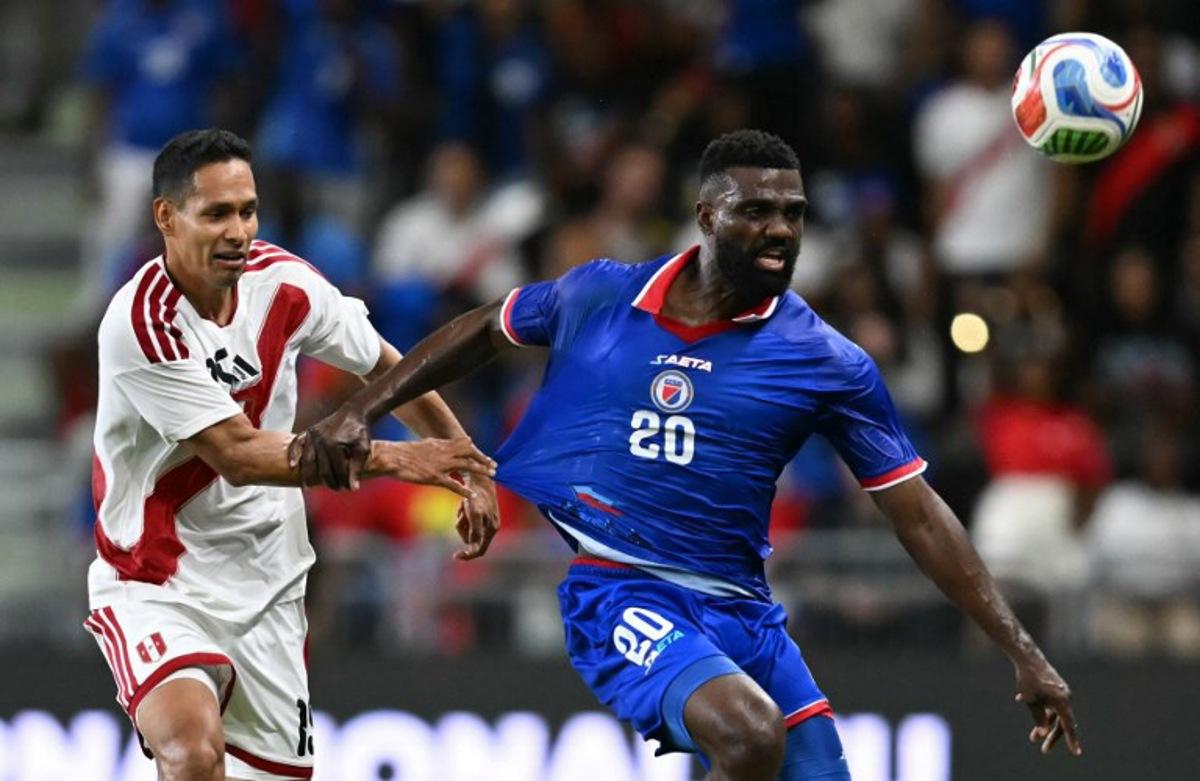 Haiti's forward #20 Frantzdy Pierrot and Peru's defender #15 Renzo Garces vie for the ball during the international friendly football match between Haiti and Peru at Nu Stadium in Miami, Florida on June 5, 2026. CHANDAN KHANNA / AFP