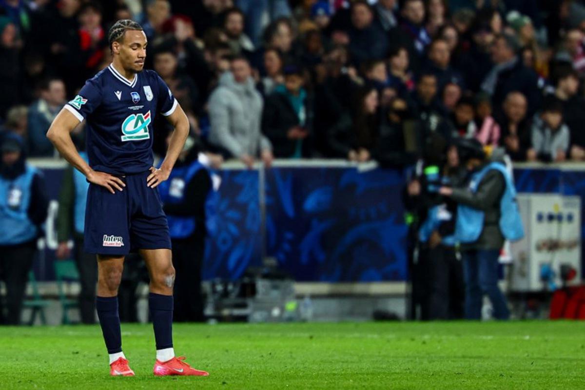 Dunkerque's French defender #21 Geoffrey Kondo reacts at end of the French Cup (Coupe de France) semi-final football match between USL Dunkerque and Paris Saint-Germain (PSG) at the Pierre-Mauroy stadium in Villeneuve-d'Ascq, northern France, on April 1, 2025. Sameer Al-Doumy / AFP