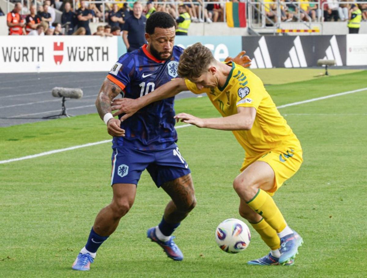 Netherlands' forward #10 Memphis Depay (L) and Lithuania's midfielder #22 Paulius Golubickas vie for the ball during the 2026 World Cup qualifiers Europe zone group G football match between Lithuania and The Netherlands, on September 7, 2025 in Kaunas, Lithuania. Petras Malukas / AFP