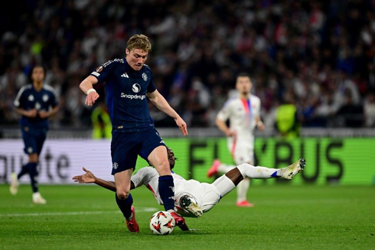 Manchester United's Danish forward #09 Rasmus Hojlund (C) fights for the ball with Lyon's Angolan defender #22 Clinton Mata between Olympique Lyonnais (OL) during the UEFA Europa League Quarter final first leg football match between Olympique Lyonnais (OL) and Manchester United at the Parc Olympique Lyonnais Groupama stadium in Decines-Charpieu, central-eastern France, on April 10, 2025. Olivier CHASSIGNOLE / AFP
