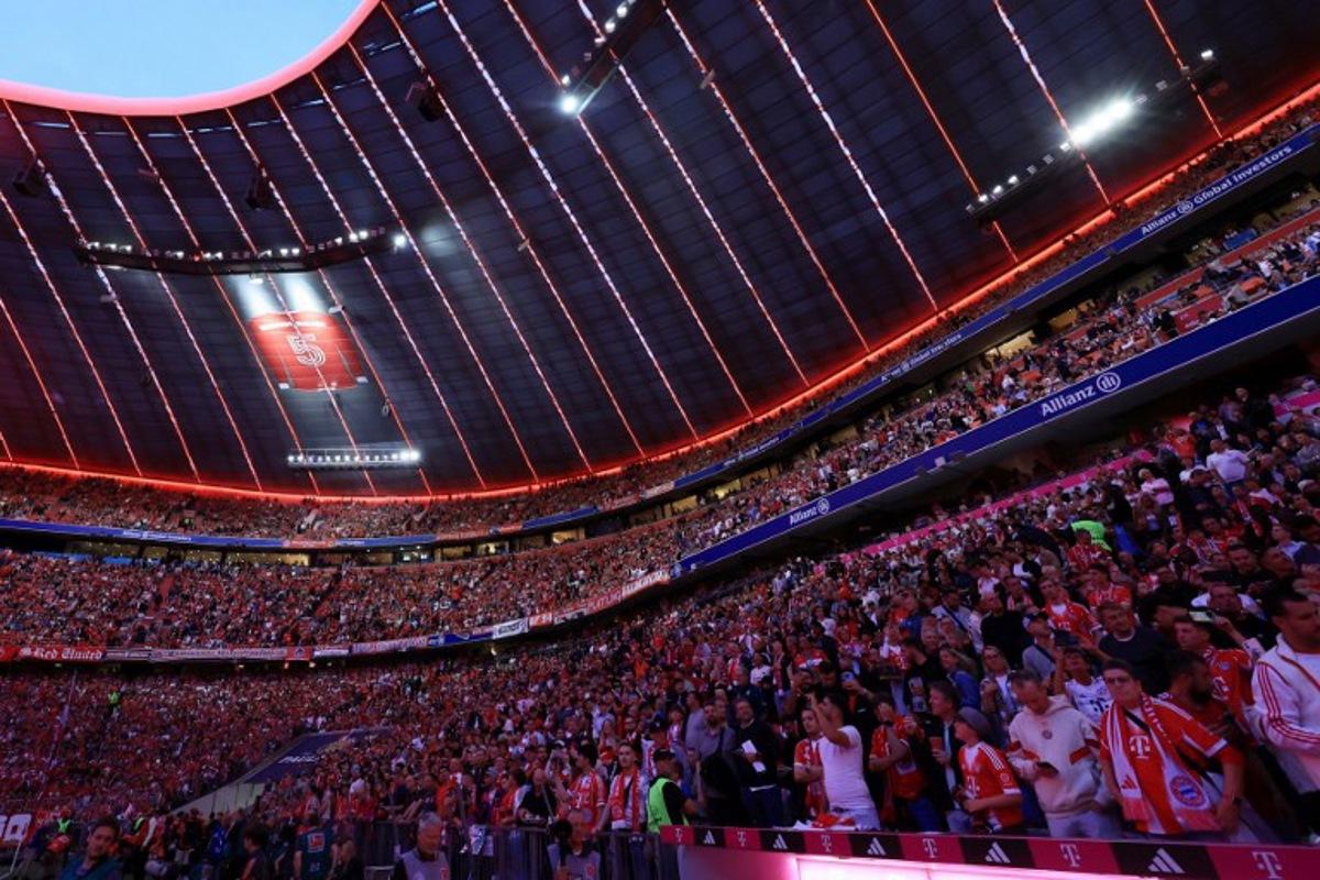 Fans gather at the Allianz Arena stadium prior to the German first division Bundesliga football match between FC Bayern Munich and RB Leipzig in Munich, southern Germany, on August 22, 2025. Karl-Josef Hildenbrand / AFP