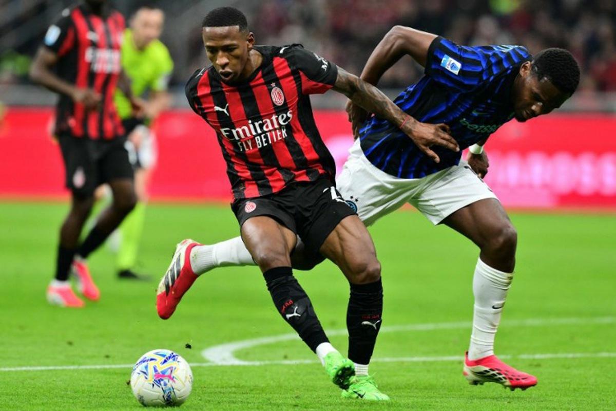 AC Milan's Ecuadorian defender #02 Pervis Estupinan (L) fights for the ball with Inter Milan's French forward #14 Ange-Yoan Bonny during the Italian Serie A football match between AC Milan and Inter Milan at San Siro stadium in Milan, northern Italy, on March 8, 2026. Stefano RELLANDINI / AFP