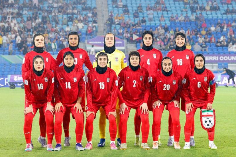Iran's team pose for a group photo before the AFC Women's Asian Cup Australia 2026 match between Iran and the Philippines in Gold Coast on March 8, 2026. The son of the late shah urged Canberra on March 9 to protect the Iranian women's football team, who were branded "wartime traitors" after refusing to sing the national anthem while playing in Australia. STR / AFP