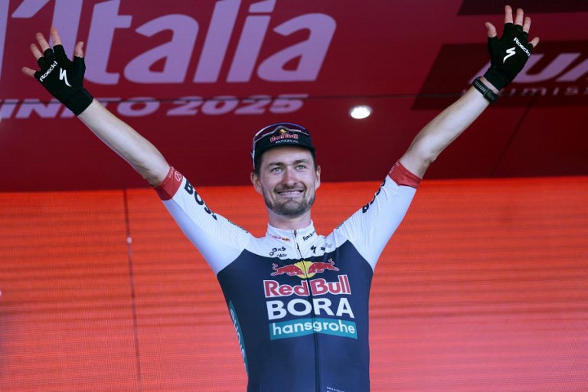 Red Bull-Bora-Hansgrohe's Germany rider Nico Denz celebrates on the podium after wnning the 18th stage of the 108th Giro d'Italia cycling race of 144kms from Morbegno to Cesano Maderno on May 29, 2025. Luca Bettini / AFP