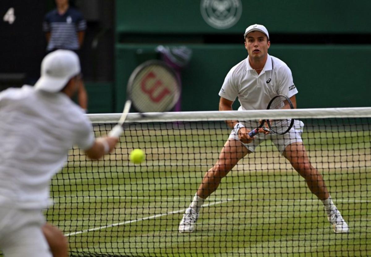 Britain's Arthur Fery (R) prepares to return to Bulgaria's Grigor Dimitrov during their men's singles round of 16 tennis match on the eighth day of the 2026 Wimbledon Championships at The All England Lawn Tennis and Croquet Club in Wimbledon, southwest London, on July 6, 2026. Glyn KIRK / AFP