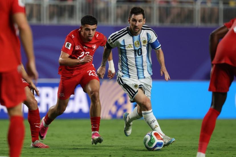 Argentina's forward #10 Lionel Messi runs with the ball followed by Switzerland's forward #23 Zeki Amdouni during the 2026 World Cup football tournament quarter-final match between Argentina and Switzerland at the Kansas City Stadium in Kansas City on July 11, 2026. Odd ANDERSEN / AFP