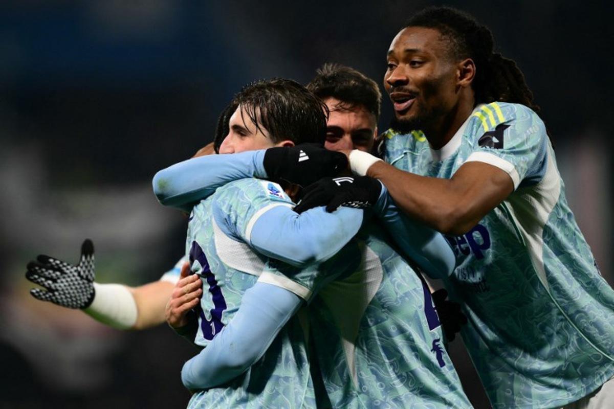 Juventus' Italian midfielder #21 Fabio Miretti celebrates with teammates after scoring his team's second goalduring the Italian Serie A football match between Sassuolo and Juventus at the Mapei - Città del Tricolore stadium in Reggio Emilia, on January 6, 2026. Marco BERTORELLO / AFP