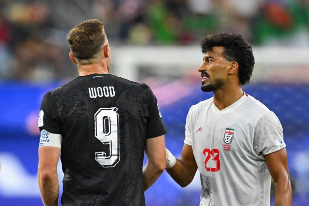 New Zealand's forward #09 Chris Wood and Iran's defender #03 Ehsan Hajsafi talk during the 2026 World Cup Group G football match between Iran and New Zealand at Los Angeles Stadium in Inglewood on June 15, 2026. Patrick T. Fallon / AFP