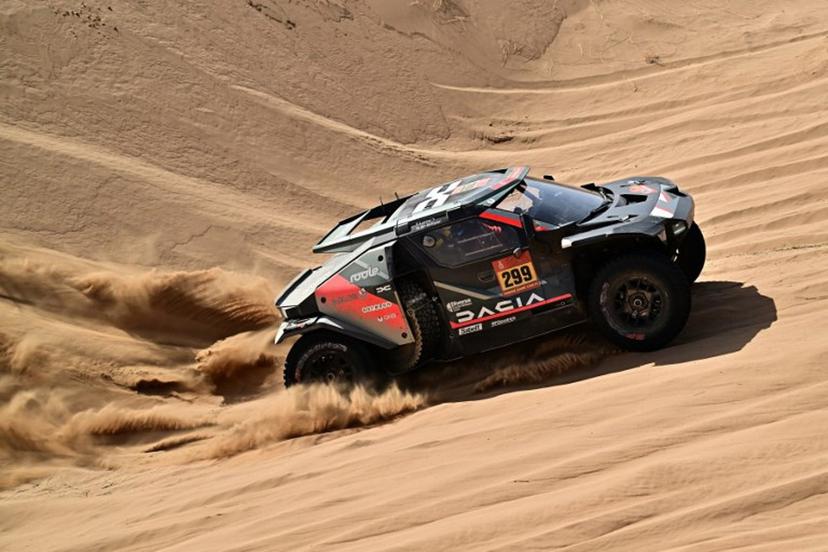 The Dacia Sandriders's Qatari driver Nasser Al‑Attiyah and Belgian co‑pilot Fabian Lurquin compete in Stage 12 of the 48th edition of the Dakar Rally 2026, between al-Henakiyah and Yanbu, Saudi Arabia, on January 16, 2026. Giuseppe CACACE / AFP