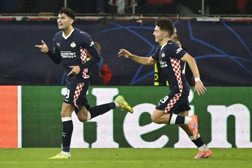 PSV Eindhoven's US forward #09 Ricardo Pepi (L) celebrates after scoring PSV's first goal during the UEFA Champions League first round day 4 football match between Olympiakos (GRE) and PSV Eindhoven (NED) at the Karaiskakis stadium in Piraeus on November 4, 2025. Aris MESSINIS / AFP