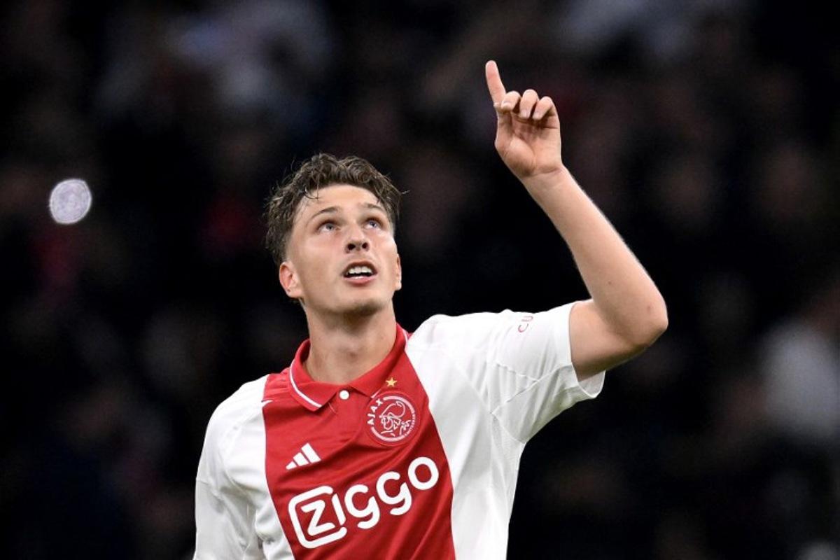 Ajax's Belgian forward #11 Mika Godts celebrates scoring his team' second goal during the UEFA Europa League football match between Ajax Amsterdam and Besiktas at The Johan Cruijff Arena Stadium in Amsterdam on September 26, 2024. JOHN THYS / AFP